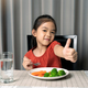 Cute little girl showing thumb showing eating healthy vegetables. - PhotoDune Item for Sale