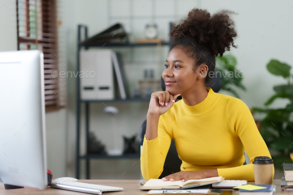 oung woman curly hair working on laptop and take note at home. - Stock Photo - Images