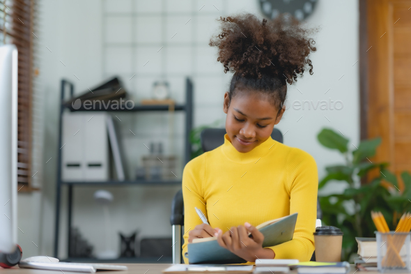 Young woman curly hair working on laptop and take note at home. - Stock Photo - Images