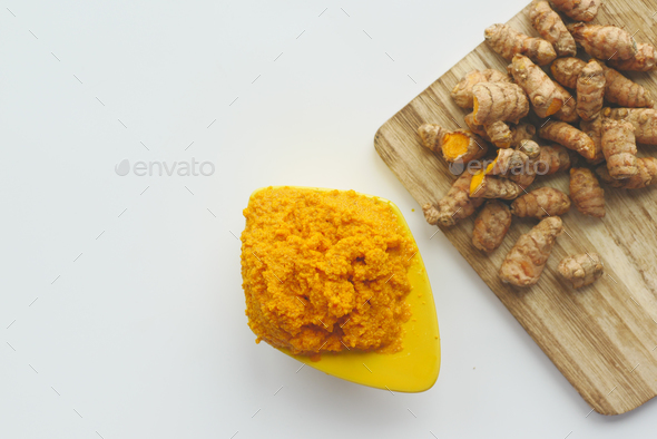  turmeric root and paste in a bowl on white background  - Stock Photo - Images