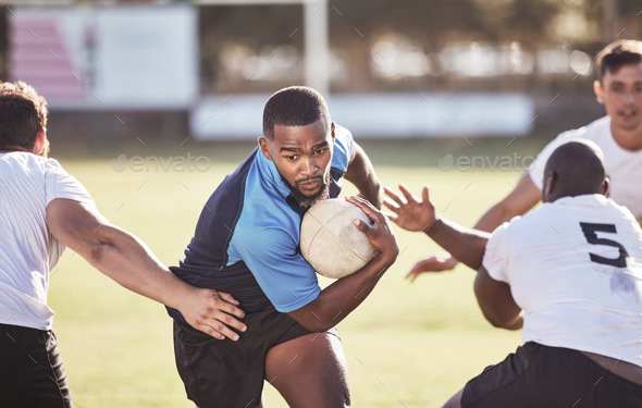 African american rugby player running away from an opponent while attempting to score a try during