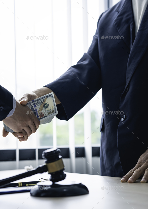 Businessman handing bribes to lawyers to help lawyers win court cases, bribery concept and getting k