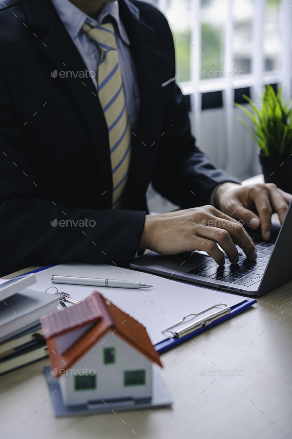 House plans with real estate agents and clients printing contract