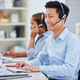 Happy young asian male call centre telemarketing agent talking on a headset while working on a comp - PhotoDune Item for Sale