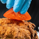 Chef Hand placing Tomato slice onto a Crispy Fried Chicken. - PhotoDune Item for Sale