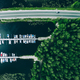 Aerial view of road with cars between green forests and blue lakes with marina boats in Finland - PhotoDune Item for Sale