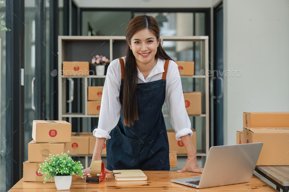 Happy asian woman work from home packaging, on line marketing packaging and delivery, SME concept - Stock Photo - Images