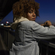 Black woman standing on the bridge at night and looking at camera - PhotoDune Item for Sale