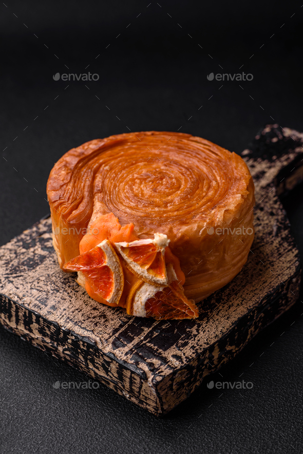 Round puff pastry croissant with citrus filling or New York roll Stock ...