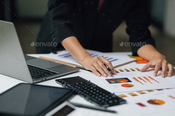 Financial consultant businesswoman analyzing charts in financial report, Analyze investment planning