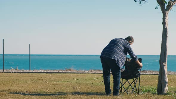 Man and Chair on the Beach