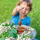 The child eats honey in the garden. Selective focus. - PhotoDune Item for Sale