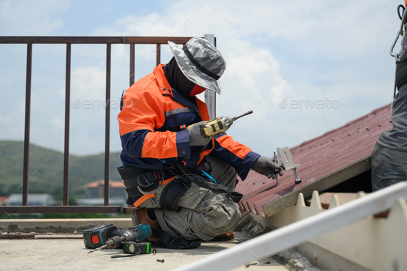 Professional engineer worker installing solar panels system on rooftop