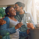 Affectionate black couple having a glass of wine by the window. - PhotoDune Item for Sale