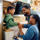 Happy black parents talking to their small son in the kitchen. - PhotoDune Item for Sale