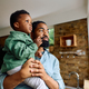 Black father and son looking through the window at home. - PhotoDune Item for Sale
