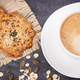 Cup of coffee with milk and fresh baked oatmeal cookies with honey and healthy seeds - PhotoDune Item for Sale