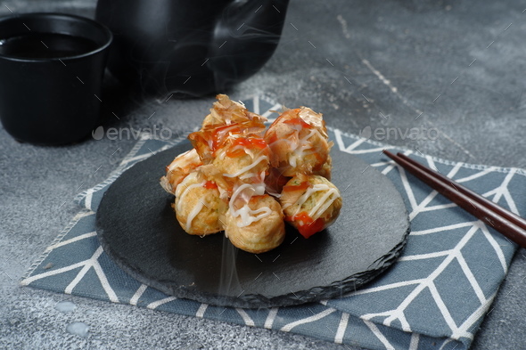 Takoyaki is one of the popular Japanese snacks-( たこ焼き), in the form of small balls filled with piece