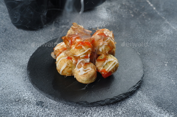 Takoyaki is one of the popular Japanese snacks-( たこ焼き), in the form of small balls filled with piece