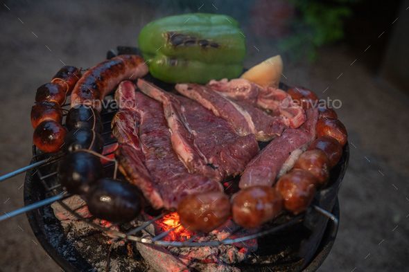 Closeup shot of typical Uruguayan and Argentine Asado cooking on a grill - Stock Photo - Images