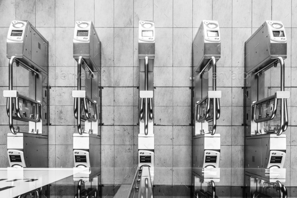 Grayscale aerial shot of automatic card scanners in a train station
