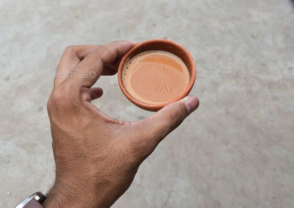 Closeup shot of a male hand holding a paper cup of coffee Stock