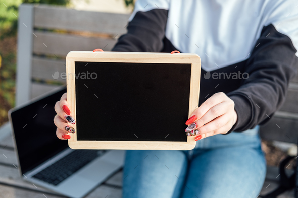 Young student girl holding black chalkboards with blank copy space screen for your advertising text - Stock Photo - Images