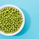 Fresh green peas in bowl isolated on blue background - PhotoDune Item for Sale