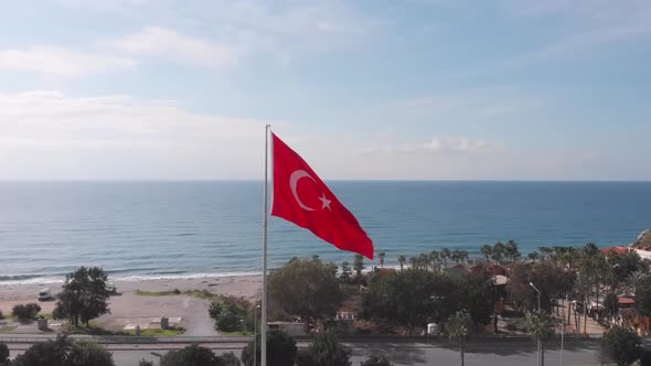 Turkish flag featuring white star waving in wind against blue sky. National flag of Turkey alt