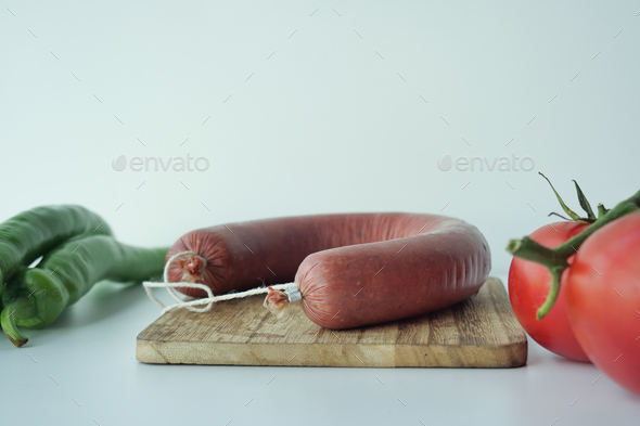 raw fresh Sausage and vegetables on table - Stock Photo - Images