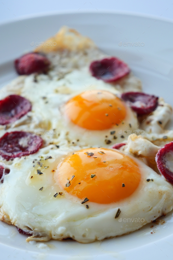fried egg mixed with sausage on a plate  - Stock Photo - Images