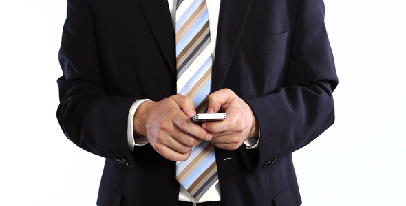 Businessman Typing Message On Cellphone
