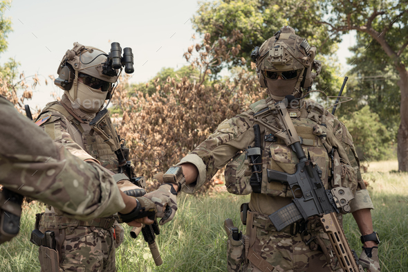 Special forces soldier in camouflage, fist bump and send energy to each ...