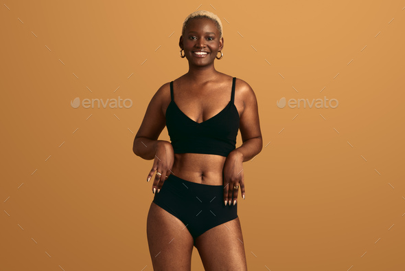 Smiling confident African woman in underwear Stock Photo by kegfire