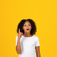 Cheerful shocked adolescent curly african american girl in white t-shirt show finger up, got idea - PhotoDune Item for Sale