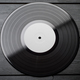 One EP vinyl record with blank label on black wooden background. - PhotoDune Item for Sale