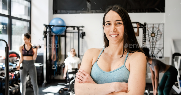 Happy Female Bodybuilder Showing Her Biceps At Camera Stock Photo