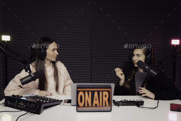 Women speaking during radio program in studio