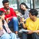 college students smiling enjoying pleasant conversation while drinking coffee - PhotoDune Item for Sale