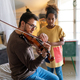 Single father and adopted daughter playing on instrument together.Adult man playing violin for child - PhotoDune Item for Sale
