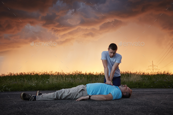 Dramatic resuscitation on rural road - Stock Photo - Images
