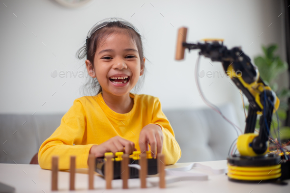 STEM education concept. Asian students learn at home by coding robot arms in STEM. - Stock Photo - Images