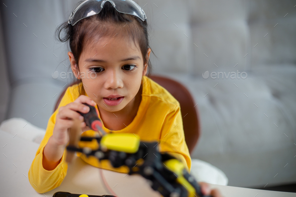 STEM education concept. Asian students learn at home by coding robot arms in STEM. - Stock Photo - Images