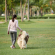 Woman Walking with Fluffy Dog - PhotoDune Item for Sale