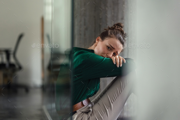 Young sad woman in office, having problem.
