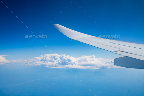 the wing of the aircraft against the background of the blue sky - Stock Photo - Images