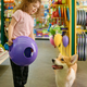 Little girl child showing her corgi dog new ball toy for playing - PhotoDune Item for Sale