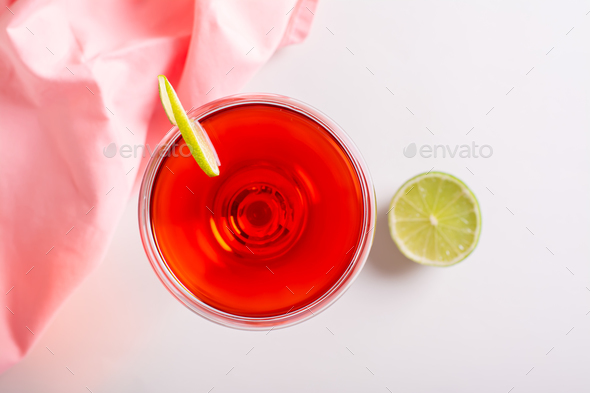 Close up of cosmopolitan cocktail with lime in glasses on the table top  view Stock Photo by Aleruana