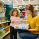 Happy mother and little daughter buying hamster cage at pet shop - PhotoDune Item for Sale