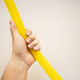 Close up of male hand holding yellow hose on background with copy space - PhotoDune Item for Sale